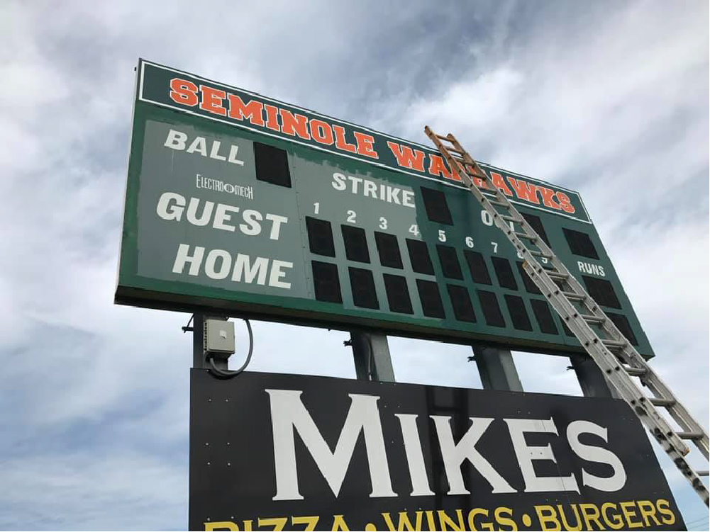 Photo of Seminole High baseball scoreboard being painted by TNT